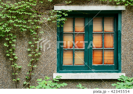 Antique wooden window frame on stone wall. 42345554