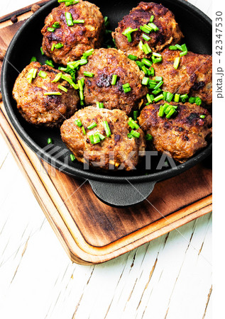 Meatballs in cast iron skillet 42347530
