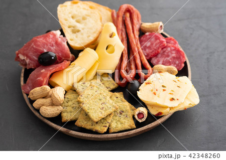 Meat and cheese plate.Traditional italian antipasto, cutting board with salami, cold smoked meat Meat and cheese plate.Traditional italian antipasto, cutting board with salami, cold smoked meat 42348260