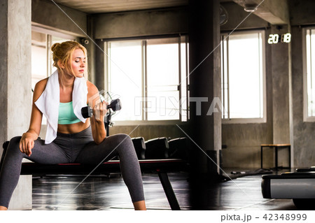 young woman exercising building muscles at the gym young woman exercising building muscles at the gym 42348999