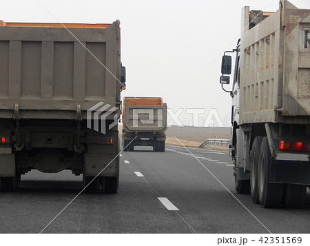 Dump trucks on the road. Dump trucks on the road. 42351569