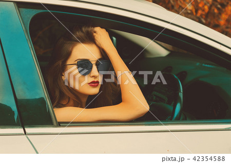 girl with glasses in the car in autumn time 42354588