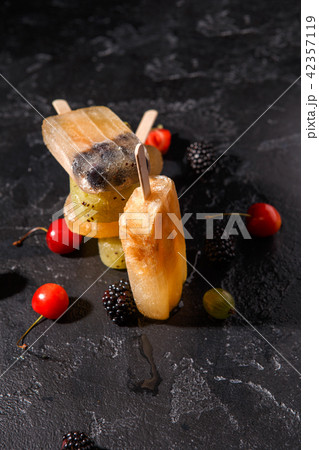 Photo of fruit ice on stick, blackberry, cherry, gooseberries Photo of fruit ice on stick, blackberry, cherry, gooseberries 42357119