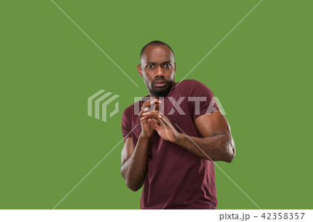 Portrait of the scared man on green Portrait of the scared man on green 42358357