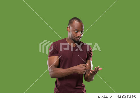 Beautiful male half-length portrait isolated on green studio backgroud. The young emotional Beautiful male half-length portrait isolated on green studio backgroud. The young emotional 42358360