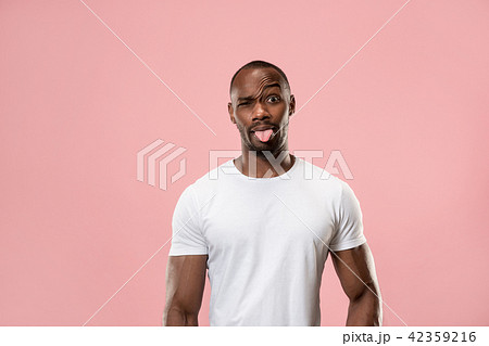 The squint eyed man with weird expression isolated on pink 42359216