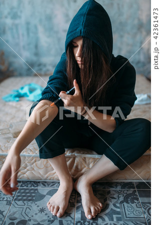Female junkie with syringe doing an injection dose 42361473