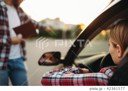 Instructor takes exam, student on driving ground Instructor takes exam, student on driving ground 42361577