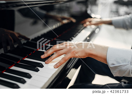 Male pianist hands on grand piano keyboard Male pianist hands on grand piano keyboard 42361733