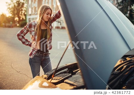 Car breakdown concept, woman against open hood Car breakdown concept, woman against open hood 42361772