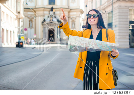 Young woman with a city map in city. Travel tourist girl with map in Vienna outdoors during holidays 42362897