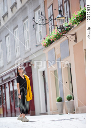 Woman walking in city. Young attractive tourist outdoors in italian city Woman walking in city. Young attractive tourist outdoors in italian city 42362933