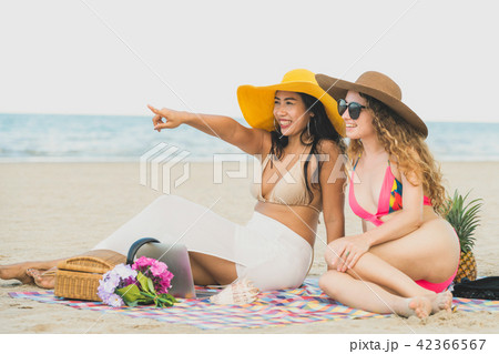 Happy women sitting on sand beach in summer. Happy women sitting on sand beach in summer. 42366567