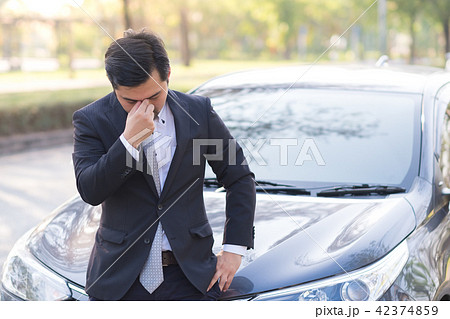 Businessman feel headache near his broken down car 42374859