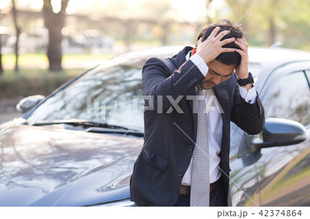 Businessman feel headache near his broken down car 42374864