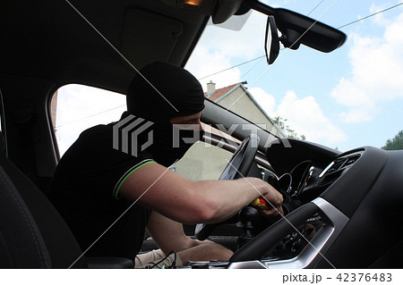 Thief with black mask in his action Thief with black mask in his action 42376483