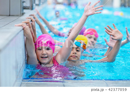 happy kids at the swimming pool. young and successful swimmers pose. 42377059