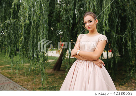 Young stylish model poses to photographer outside Young stylish model poses to photographer outside 42380055