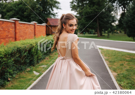 Young stylish model poses to photographer outside 42380064