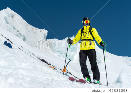 A freerider skier in complete outfit stands on a glacier in the North Caucasus 42381093
