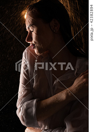 Young woman in sexy wet shirt in shower view 42382894
