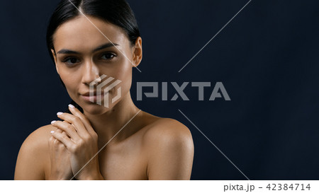 Beautiful woman holding her black hair 42384714