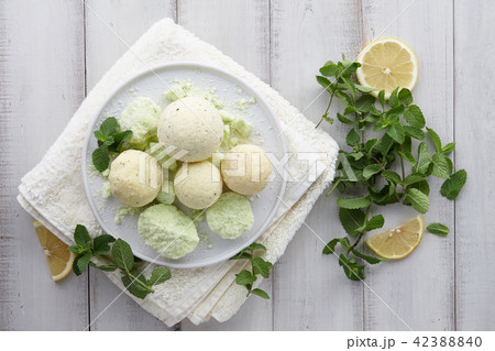 Handmade mint bath bombs and towel on white planks 42388840