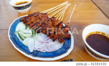 SINGAPORE - APR 3rd, 2015: Delicious tasty skewers of chicken cook over hot coals in Singapore's SINGAPORE - APR 3rd, 2015: Delicious tasty skewers of chicken cook over hot coals in Singapore's 42391530