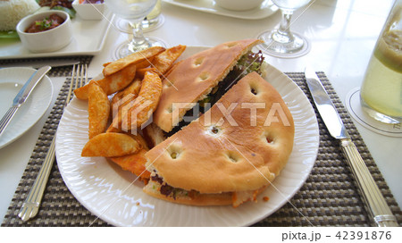 PULAU LANGKAWI, MALAYSIA - APR 4th 2015: Chicken focaccia sandwich with potato wedges PULAU LANGKAWI, MALAYSIA - APR 4th 2015: Chicken focaccia sandwich with potato wedges 42391876