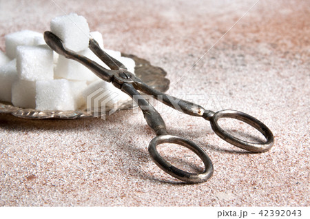 Cubes of white sugar in a vintage metal saucer Cubes of white sugar in a vintage metal saucer 42392043