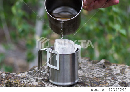 Pouring boiling water into coffee. 42392292