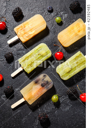 Photo of ice cream on stick, blackberry ,cherry, gooseberry Photo of ice cream on stick, blackberry ,cherry, gooseberry 42392485