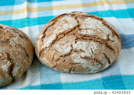 Fresh rustic bread on a checkered towel 42403935