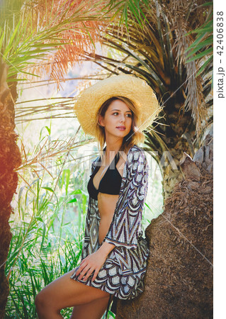 girl in bikini and hat have rest in palm forest 42406838