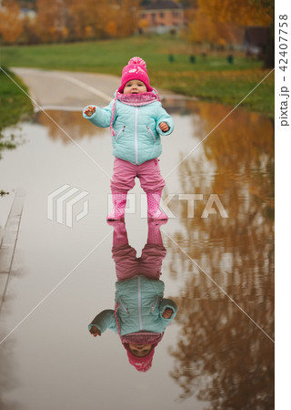 little girl with rubber boots in puddle little girl with rubber boots in puddle 42407758