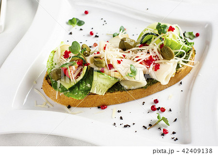 Bruschetta with pesto sauce, fish, fresh vegetable Bruschetta with pesto sauce, fish, fresh vegetable 42409138