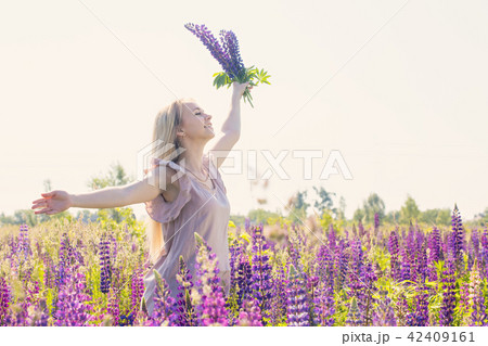 Free and happy woman with bouquet of lupines 42409161