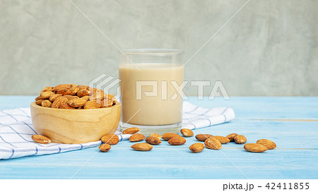 Almond milk on a blue wooden table. 42411855