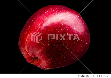 Single delicious red apple on black background 42414095