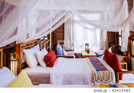 Bedroom interior four poster bed colourful fabric 42415485