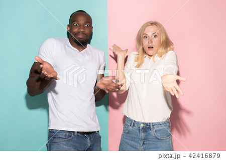 Closeup portrait of young couple, man, woman. One being excited happy smiling, other serious Closeup portrait of young couple, man, woman. One being excited happy smiling, other serious 42416879