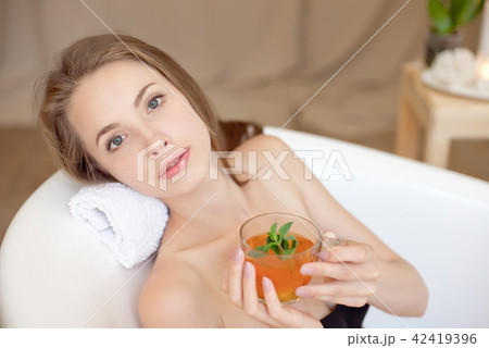 Caucasian smiling woman after spa covered with white towel 42419396