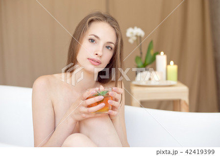 Caucasian smiling woman after spa covered with white towel 42419399