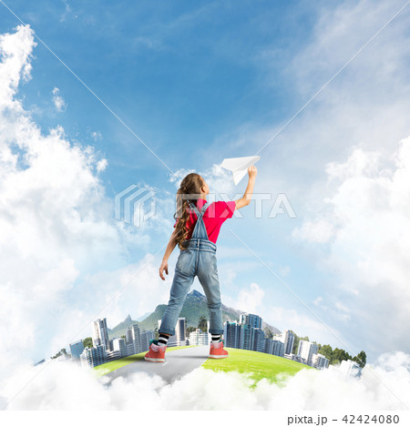 Concept of careless happy childhood with girl dreaming about future 42424080