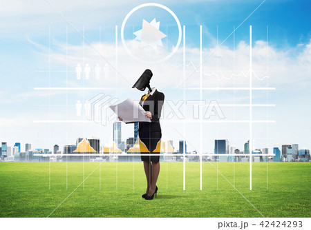 Camera headed woman standing on green grass against modern cityscape Camera headed woman standing on green grass against modern cityscape 42424293