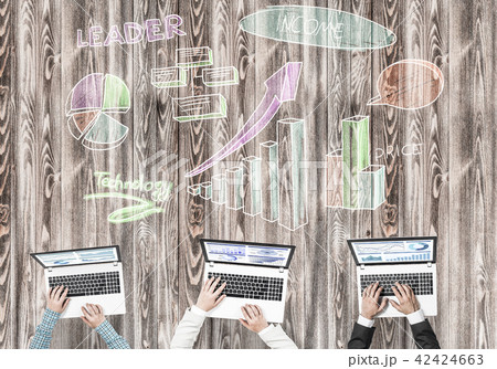 Top view of businesspeople sitting at table and using gadgets 42424663