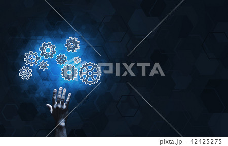 Glowing cogwheel mechanism icon on dark background as symbol of teamwork 42425275