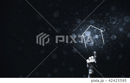 Conceptual image with hand pointing at house or main page icon o 42425595