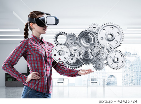 Girl in casual wearing VR glasses and experiencing virtual reality. Mixed media Girl in casual wearing VR glasses and experiencing virtual reality. Mixed media 42425724