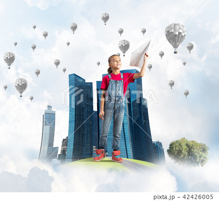 Concept of careless happy childhood with girl dreaming about future 42426005